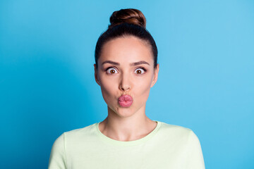 Portrait of lovely lady look in camera with lips pouted air kiss send concept isolated over blue color background
