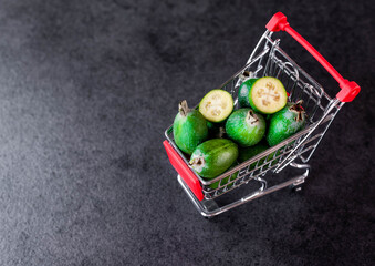 Feijoa close up in shopping cart as shopping concept with copy space.