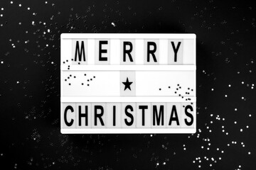 Merry Christmas lettering on lightbox.Festive composition