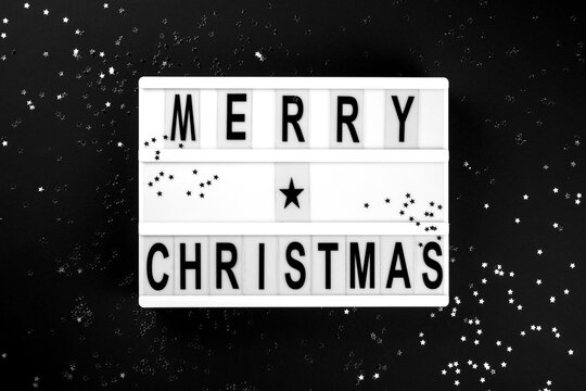 Naklejki Merry Christmas lettering on lightbox.Festive composition