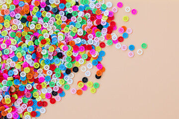 Button plastic colorful on peach color background.