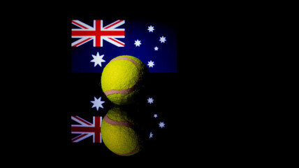 Yellow Tennis Ball on black mirror with Australian Flag in the background