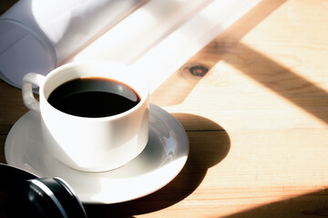 Coffee on the wooden desk in the afternoon.