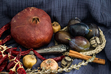 Still life with dried fruits, vegetables and herbs on dark grey textured background. Top view photo of different objects. Colors of autumn.