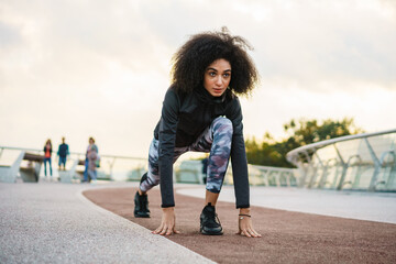 Fototapeta premium Young athletic sportswoman doing exercise while working out