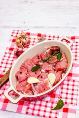 Raw veal cut into pieces with vegetables and other ingredients ready to cook