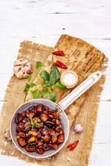 Ready to eat hot fried brown champignons in vintage pan