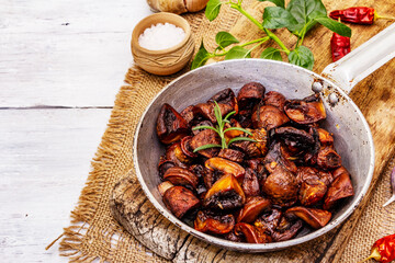 Ready to eat hot fried brown champignons in vintage pan