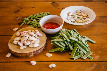 vegetables for paella on wooden table.