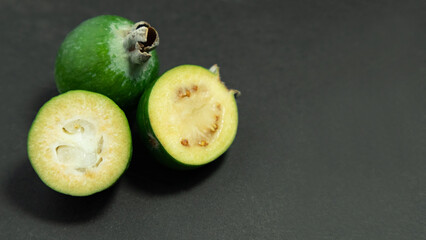 Feijoa fruits on black background. Tropical ripe feijoa fruits.
