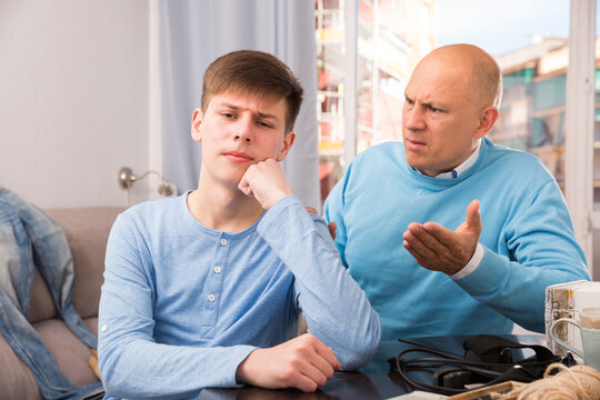 Portrait of angry father quarreling with his teenage son