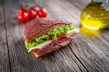 Assorted sandwiches on wooden background