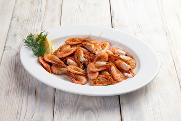 Cooked shrimps in a plate. On a light background. Selective focus