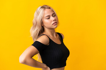 Fototapeta premium Young Russian woman isolated on yellow background suffering from backache for having made an effort