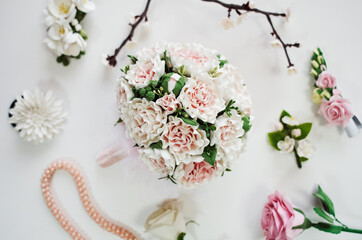 Handmade floral tiara and bouquet made flowers on white background. Fashionable wreath head wear in close up.Hand crafted decorative fashion accessories for women