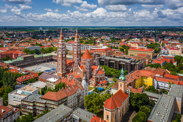 Fototapeta na wymiar Szeged, Hungary - Aerial view of the Votive Church and Cathedral of Our Lady of Hungary (Szeged Dom) on a sunny summer day with blue sky and clouds