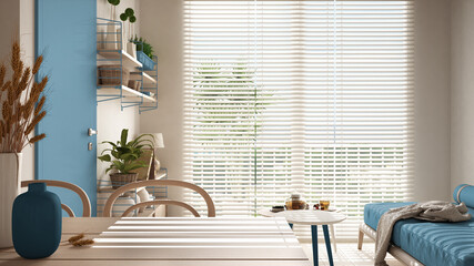 Cosy wooden sustainable living room in blue tones. Dining table with vases and ears of grain. Sofa, two coffee tables with teapot and tea cup. Environmental friendly interior design