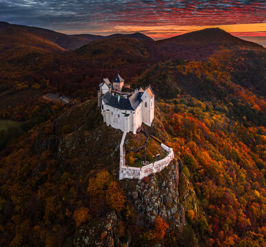 Fuzer, Hungary - Aerial view of the beautiful Castle of Fuzer with amazing colorful sunrise sky and clouds on an autumn morning. The castle has been located in the mountains of Zemplen
