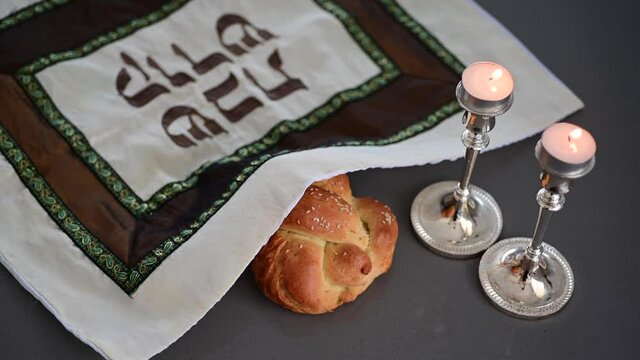 Challah bread and Sabbath candles on table