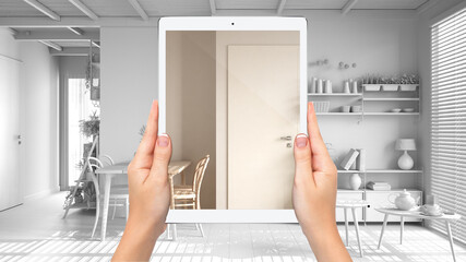 Hands holding tablet showing cosy dining room with table, total blank project background, augmented reality concept, application to simulate furniture and interior design products