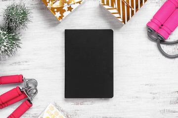 Mockup blank cover black book for New Year resolutions healthy background concept on grunge whtie Christmas ornaments and fitness equipments. Mock up blank cover black book.
