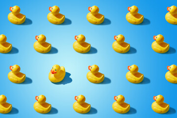 Fashion minimalistic concept of a yellow rubber duck pattern flat lay. Not like everyone else, goes against the system.