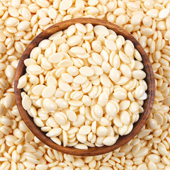 Wooden bowl full of natural wax granules. Waxing or hair removal concept