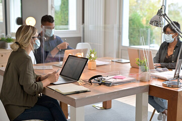 Multiracial staff at work in cowork office - Young people wearing surgical mask for coronavirus