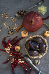 Still life with dried fruits, vegetables and herbs on dark grey textured background. Top view photo of different objects. Colors of autumn.
