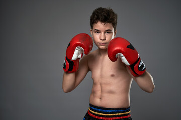 Teenage boxer with red gloves