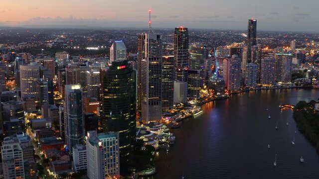 High-Rise Buildings And City Skyline At Twilight Colorful Evening In Brisbane, Capital Of Queensland, Australia. - Aerial Shot