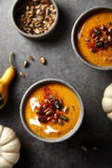 pumpkin mashed soup in a glass on a dark background