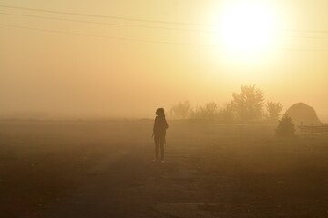 person walking in the fog