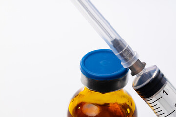 Medical vial with medication and syringe close up