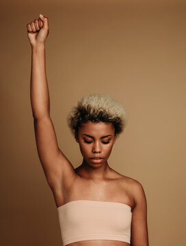 African american woman standing with raised arm