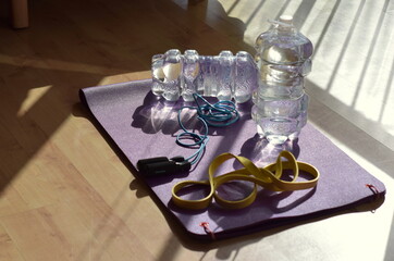 Training at home because of covid, jugs of water, purple mat 