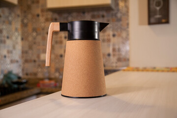 Coffee thermos bottle with cup, placed on the counter of a Brazilian kitchen.
Kitchen as a background. Coffee concept. Brazil concept.