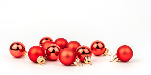 Small red Christmas balls on a white isolated background. A bunch of balls.