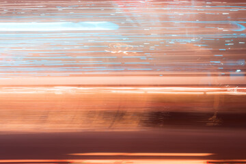 Abstract blue orange light trails in the dark, motion blur effect. Long exposure city lights from...