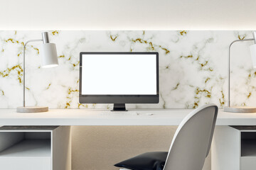 Interior of stylish office with computer on table with blank white screen.
