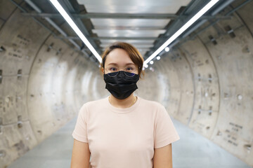 New normal asian beauty Wear a mask to prevent Covid 19 viruses or coronavirus. Scaffolding with Smiling under the mask. Social distancing and and keep distance concept.
