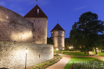 Fototapeta na wymiar Illuminated towers and roof in the Old Town of Tallinn, Estonia