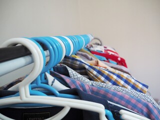 Many clothes with hanger in room