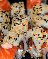 
Different kind of rolls and sushi isolated on black plate