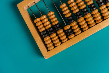 Top view of vintage abacus on a green background, the concept of mathematical calculations