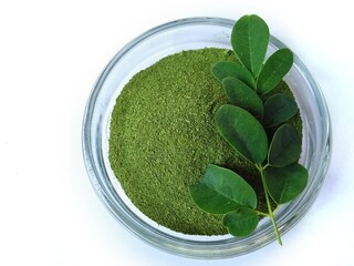 Moringa leaves and flowers (Moringa oleifera) Moringa powder capsules Isolated on a white background Moringa powder for making tea(herbs)	
