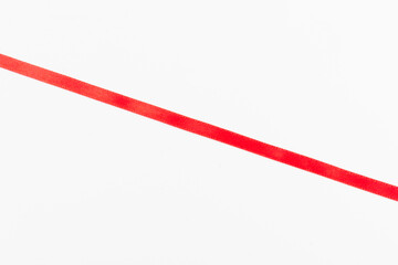 Top view of Red ribbon isolated shiny rolled on white background. Flat lay view.