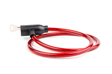 Flexible red bicycle cable with key on white background.  Security and safety concept.