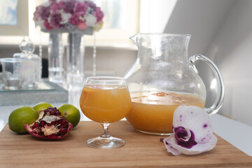 Refreshing freshly squeezed orange juice filled in glass and carafe