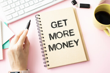 Handwritten text sign showing Get More Money. Conceptual photo More Traffic Leads Online Page Promotion Popularity Traffic written Notebook Book Writing Holding Pen wooden background.
